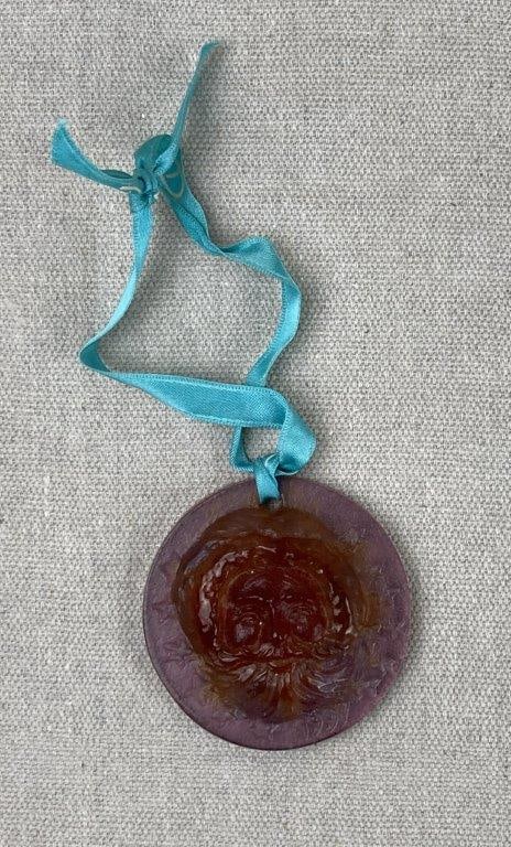 Santa Claus Christmas Ornament by Daum France: This exquisite holiday ornament is crafted by the renowned French glassmaker Daum using the intricate "pâte de verre" technique. The medallion features a finely detailed relief of Santa