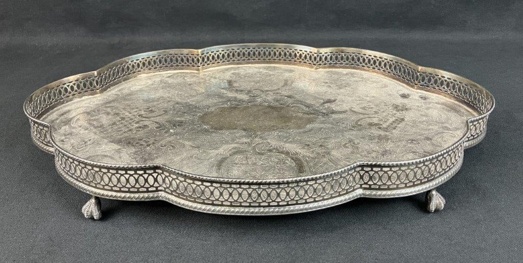 English Silverplate Tray: Elegant Sheffield reproduction silverplate tray featuring scrollwork decoration, a pierced reticulated gallery, and ball and claw feet. Marked to the underside as silverplate over copper and modeled