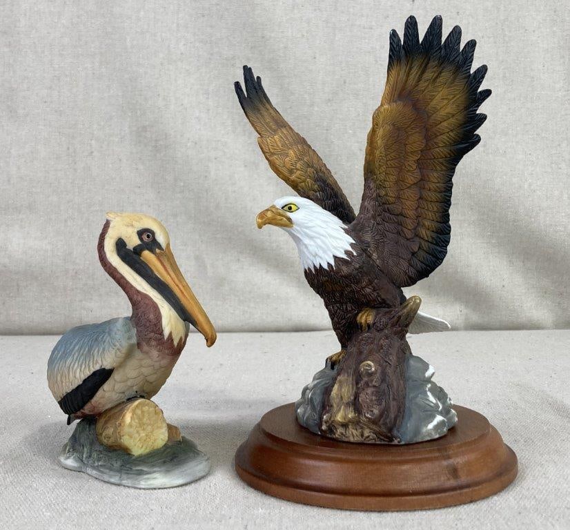 Eagle and Pelican Figures: A duo of avian sculptures featuring two distinct species rendered in different mediums. The first is a detailed resin Bald Eagle, captured in a majestic pose perched upon a log and securely mounted on
