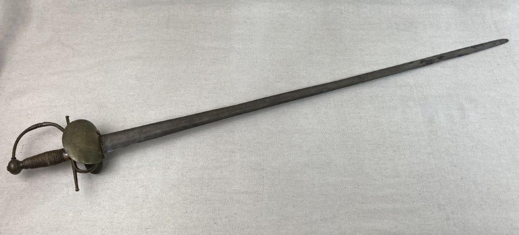 Early Spanish Cavalry Sword: Sword with double shell guard and slender straight blade, reflecting classic cavalry form. Measures approximately 42â€³ H x 6 1/4â€³ W x 3â€³ D. Deep