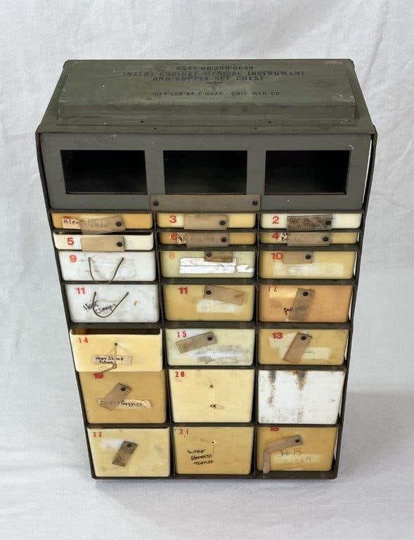 Military Medical Supply Cabinet: Cabinet with multiple compartments designed for organized storage, in a practical utilitarian form suitable for medical or general use. Measures approximately 31â€³ H x 17