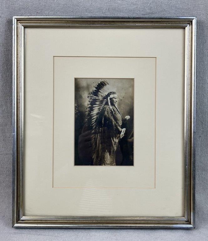 Native American Cheyenne Portrait Photograph: Portrait photograph depicting a Cheyenne figure in ceremonial dress with a large headdress, likely produced using a silver gelatin process. Housed in a gilt frame. Frame measures approximately 12