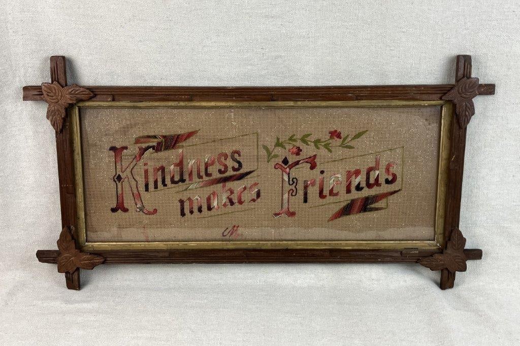 Motto Needlepoint in Criss-Cross Frame: Folk art needlepoint motto reading â€œKindness Makes Friends,â€ housed in a criss-cross wood frame with leaf detailing and traditional construction. Frame measures