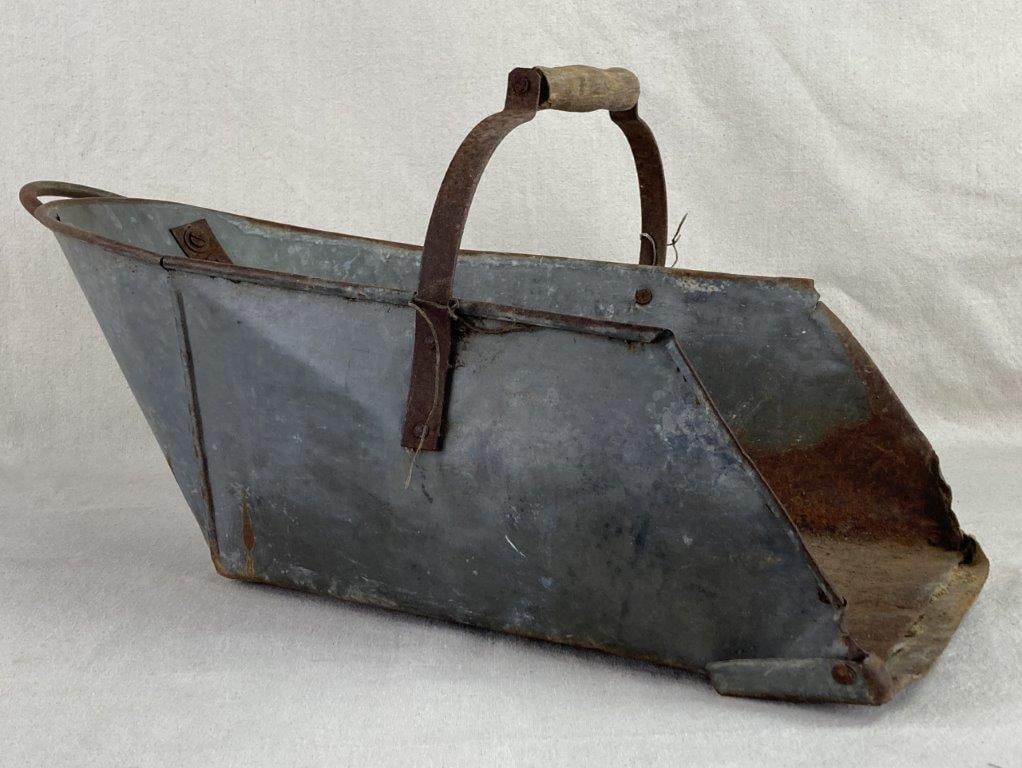 Primitive Aluminum Coal Scuttle: This primitive steel coal scuttle is a robust example of traditional hearthside utility, featuring a classic open mouth shape designed for efficient loading and pouring. It is equipped with a sturdy