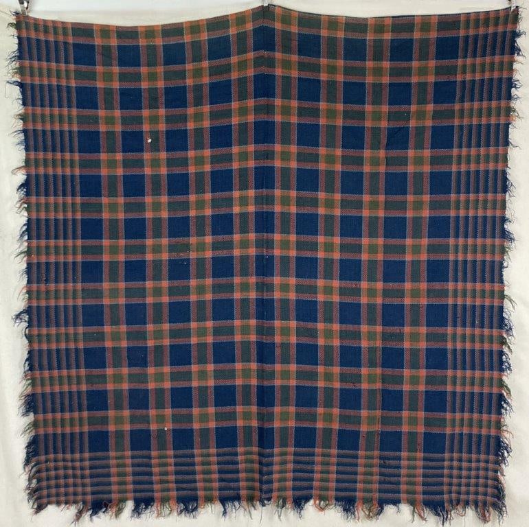 Buffalo Pattern Coverlet: Woven coverlet in a buffalo pattern, executed in blues, reds, and greens, with a bold, graphic textile design. Measures approximately 79â€³ H x 77 1/2â€³ W. Wear with