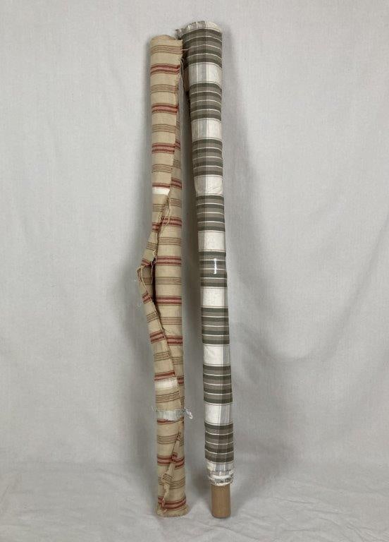 Decorative Fabric Rolls: Two rolls of decorative fabric offering charming textures and patterns for smaller upholstery projects or craft applications. The first roll features a classic ticked weave on a cream ground,