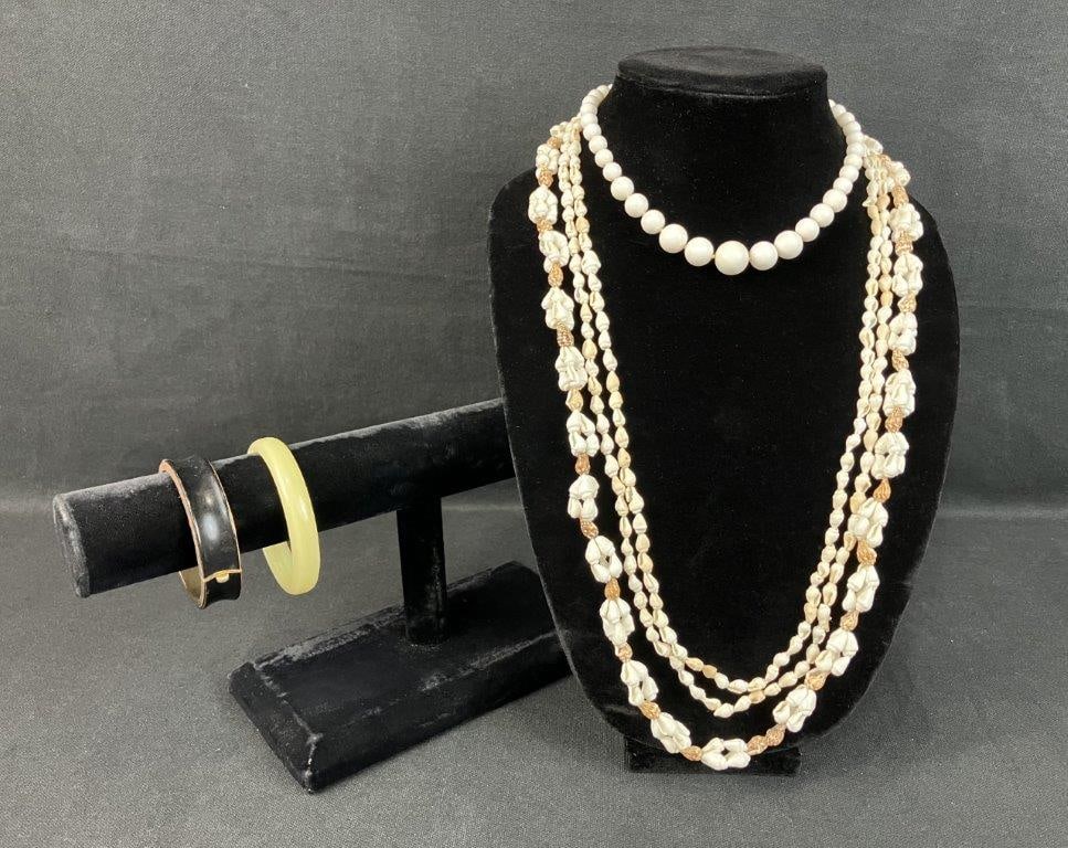 Group of Vintage Costume Jewelry: Assorted group including two shell necklaces, one beaded necklace, and two bangles. One necklace measures approximately 54â€³ in length, and one bangle has an inner diameter of approxi
