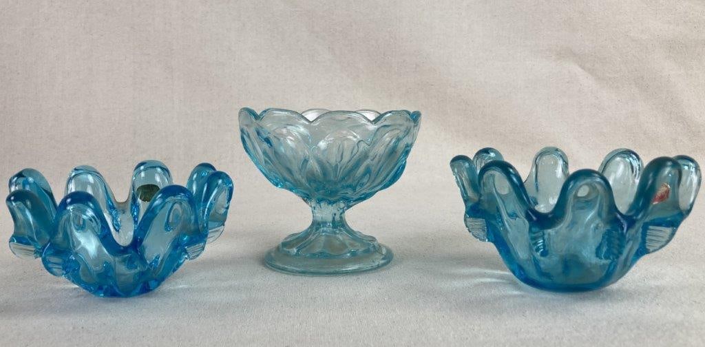 Art Glass Sherbet Dish and Bowls: A set of three striking art glass pieces in a rich, vibrant blue hue, showcasing the bold saturation and fluid forms typical of mid-century table top design. The collection features a sherbet dish
