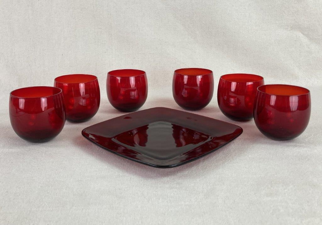 Ruby Red Glasses and Plate: This striking jewel-toned assembly features six rounded ruby red glasses paired with a coordinated rounded square serving plate, creating a bold visual statement for a vintage table setting. The