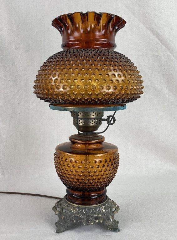 Gone with the Wind Amber Hobnail Glass Hurricane Lamp: A striking example of Victorian-style lighting, this "Gone with the Wind" hurricane lamp features a richly textured hobnail pattern across both its ruffled top shade and its bulbous lower glass