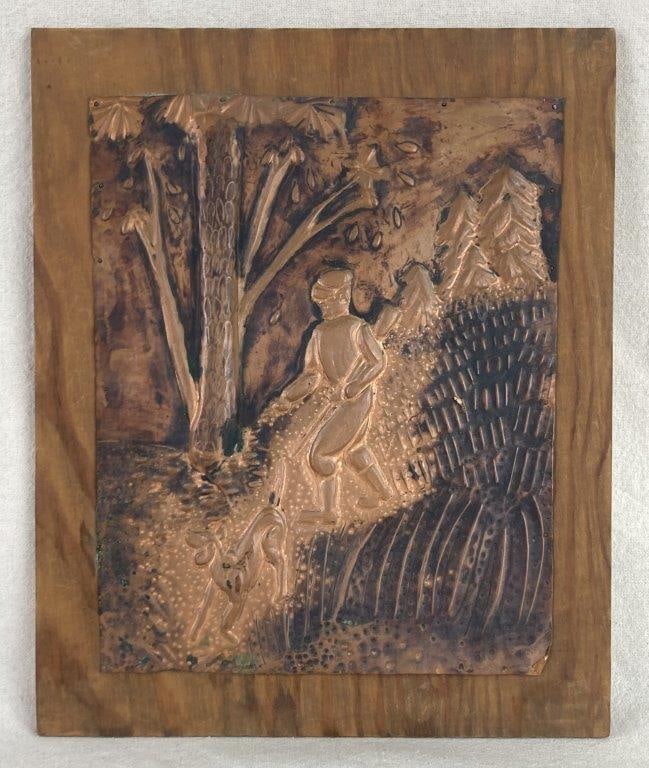 Folk Art Copper Hunting Scene: A charming folk art piece featuring a pressed sheet of copper that depicts a hunter and his dog trekking through a dense forest. The artwork showcases intricate hammered details that provide texture