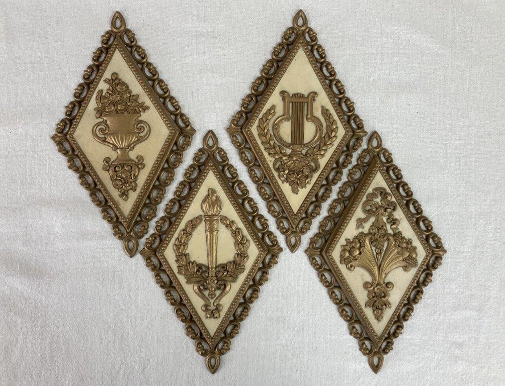 Mid-Century Modern Homco Wall Plaques: A complete set of four diamond-shaped molded plastic plaques by Homco. The collection features a variety of neoclassical and pastoral motifs, including a vessel with florals, a stringed instrument, a