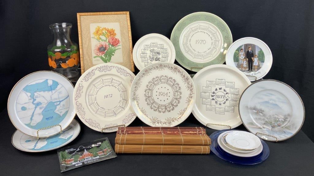 Decorative Assortment: Group including a framed floral print, a vintage orange-decorated vase by Anchor Hocking, and thirteen plates featuring varied designs including one with John F. Kennedy, Asian-inspired motifs, and