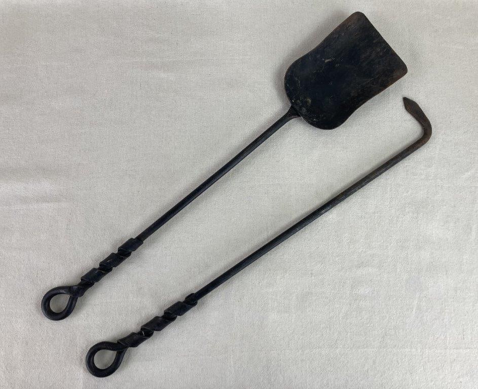 Iron Fireplace Scoop and Poker: This pair of black iron fireplace tools consists of a sturdy scooper and a matching poker. Each piece features distinctive wrapped metal detailing around the handles, providing both a decorative