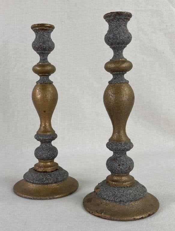 Painted Mahogany Candlesticks: This pair of painted mahogany candlesticks features a classic turned pedestal design, blending the structural elegance of mahogany wood with a sophisticated gold and silver-tone finish. The surface