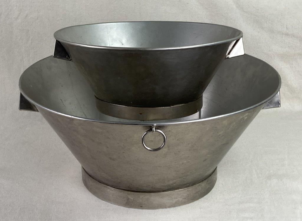 Two Aluminum Wine Buckets: This duo of crafted aluminum wine buckets offers a sleek, industrial aesthetic for entertaining or vintage barware display, featuring one larger and one smaller vessel. Both bucket are adorned by a fu
