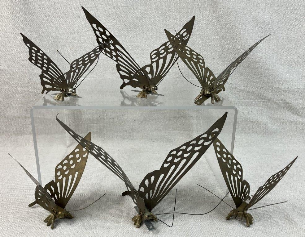 Mid Century Modern Brass Butterflies: Group of six decorative brass butterflies with delicate wing forms, suitable for display. One measures approximately 7 3/8â€³ H x 4â€³ W x 7 1/2â€³ D. S