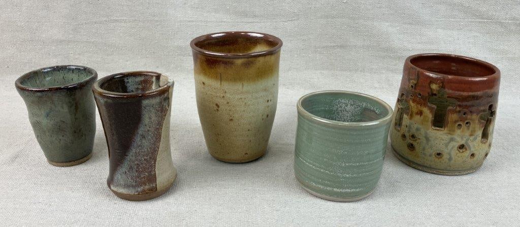 Studio Pottery Assortment: Group of five studio pottery pieces, some signed, featuring soft celadon glazes alongside speckled earth-tone finishes. The tallest measures approximately 4 3/8â€³ H x 3
