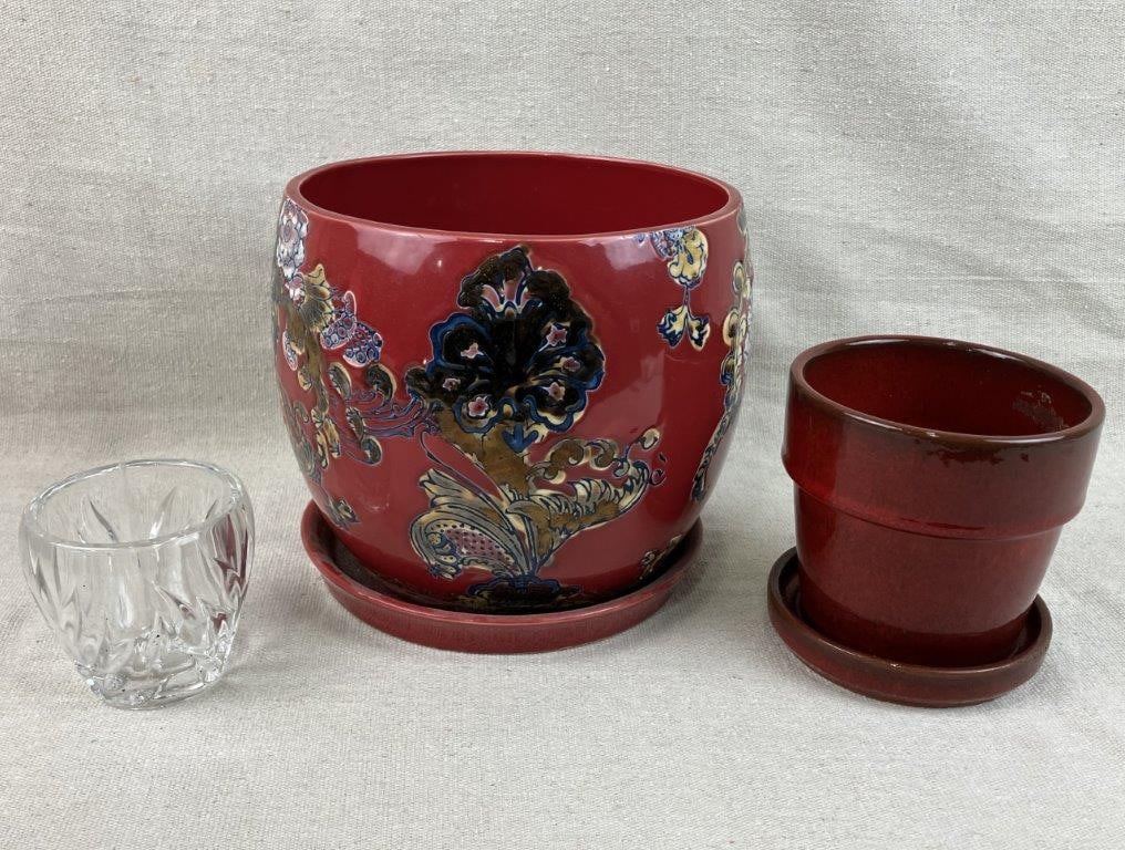 Pair of Ceramic Planters: Group including two ceramic planters, one with a rich red glaze and floral decoration, and another smaller example with a terracotta clay body, accompanied by a glass cup. The larger measures approxim