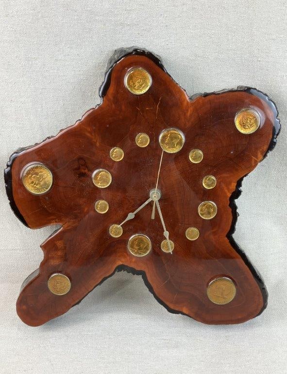 Mid Century Modern Tree Slice and Coin Wall Clock: Wall clock in a tree slice form with a glossy finish, featuring embedded vintage coins serving as hour markers, characteristic of 1970s decorative design. Measures approximately 15
