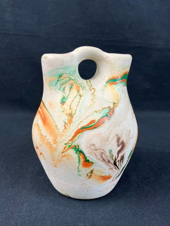 Native American Wedding Vase: Wedding vase with vibrant swirl patterning, marked for Nemadji Indian Pottery at the base, reflecting the distinctive marbled finish associated with the maker. Measures approximately