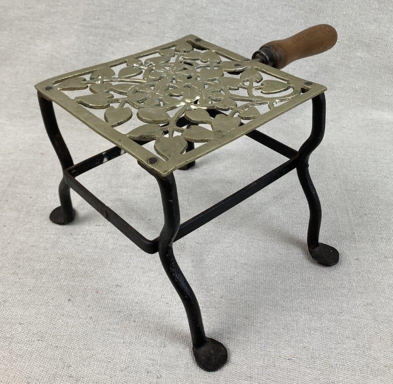 Early Brass and Iron Trivet: Ornate trivet featuring an openwork reticulated brass top with decorative design, supported by wrought iron legs, combining function with visual appeal. Measures approximately 6