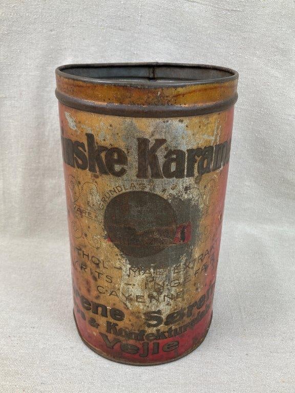 Vintage Advertising Tin: Metal tin with lithographed printed decoration, cylindrical form. Measures approximately 10 1/2â€³ H x 6â€³ in diameter. Some wear with bends to metal.