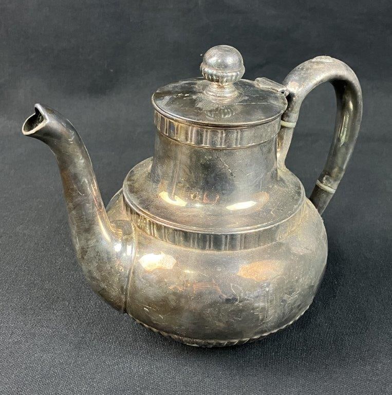 19th Century Silverplate Teapot: Silverplate teapot bearing the mark of Wilcox, featuring neoclassical ribbing and a balanced geometric form. Measures approximately 7â€³ H x 7 3/4â€³ W x 4