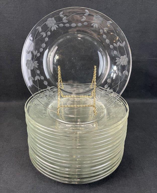 Sixteen Etched Glass Plates: Set of sixteen clear glass plates with etched rims, featuring a delicate flower and berry pattern. One measures approximately 3/4â€³ H x 7 7/8â€³ in diameter. Good