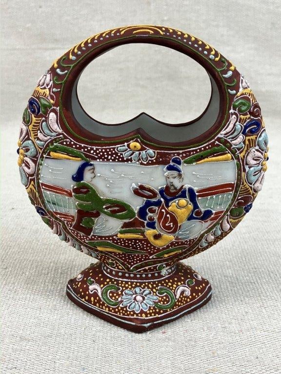 Satsuma Moon Shape Basket: Japanese porcelain basket in a moon-shaped form, decorated in the Satsuma style with raised moriage detailing, presenting an ornate and finely textured surface. Measures approximately 5