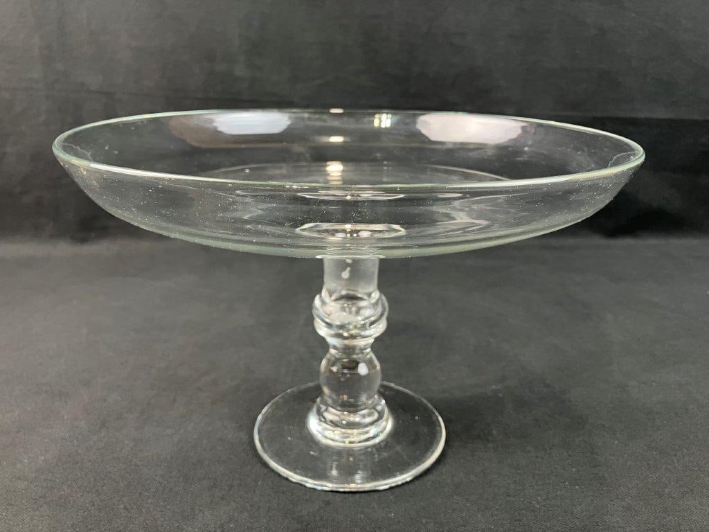 Glass Compote: Blown glass compote with pedestal base, suitable for display or serving. Measures approximately 6 3/4â€³ H x 10 5/8â€³ in diameter. Good condition.