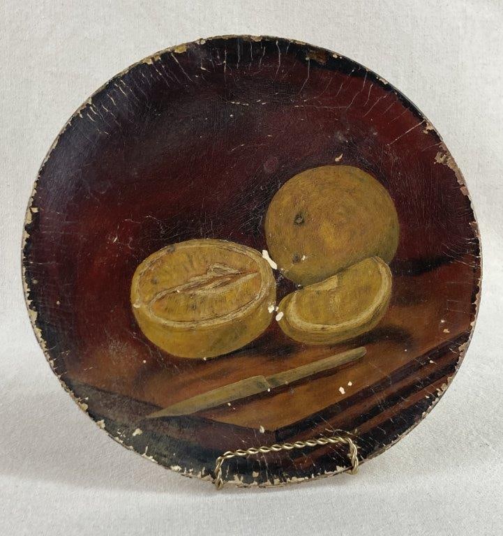 19th Century Still Life Papier Mache Plate: An antique decorative plate crafted from papier-mÃ¢chÃ©, featuring a hand-painted still life of lemons resting on a cutting board alongside a knife. This piece represents the