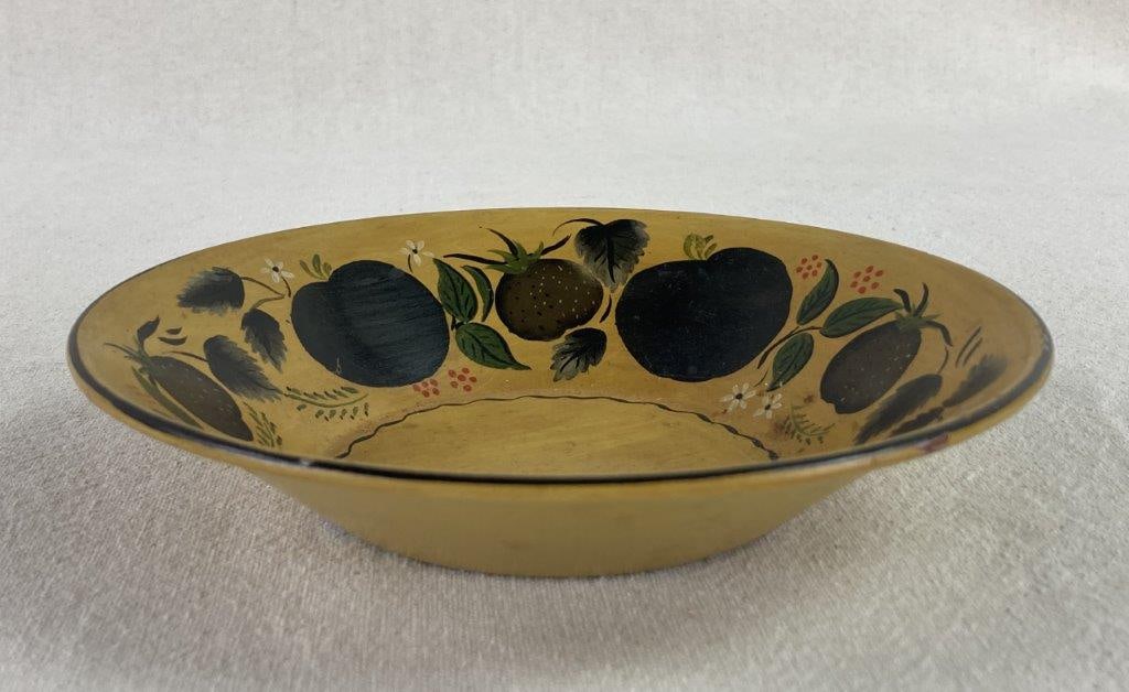 Mid-Century Modern Painted Toleware Bowl: A vibrant example of mid-century decorative metalware, this hand-painted toleware bowl features a warm mustard yellow background accented by a ring of dark fruit motifs around the rim. The bowl