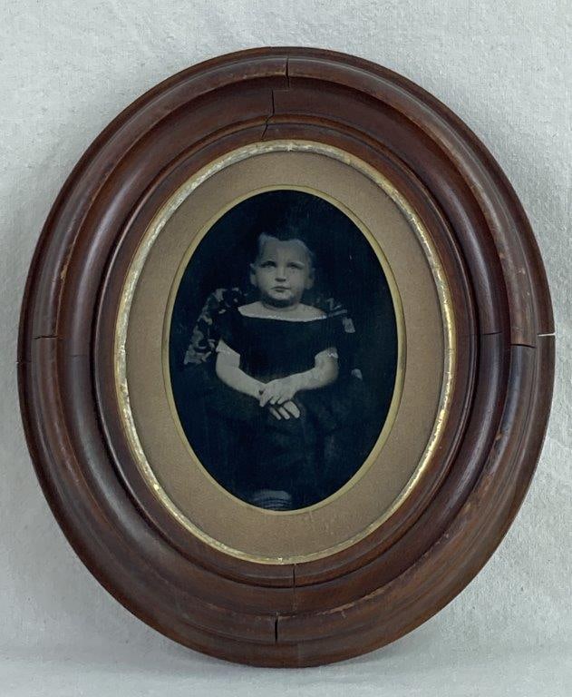 19th Century Photograph Portrait of Young Girl: This poignant 19th-century photograph captures a seated young girl in a formal black dress detailed with unique spots on the skirt. The image features delicate hand-colored highlights, a traditional