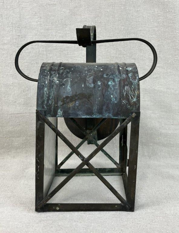 Tin Lantern: Tin lantern light fixture with a copper finish and rich patina throughout. Measures approximately 10â€³ H x 7â€³ W x 7â€³ D. General surface wear with