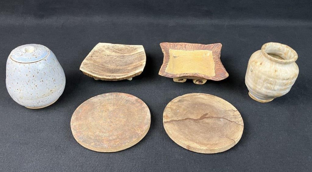 Studio Pottery Assortment: Assorted group of studio pottery including vessels, coasters, and related forms, each displaying individual hand-crafted character and glaze variation. One lidded vessel measures approximately 3