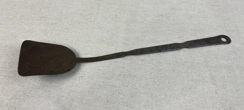19th Century Hand-Forged Spatula: Hand-forged spatula demonstrating traditional blacksmith craftsmanship, with a simple utilitarian form. Measures approximately 13â€³ H x 2 1/2â€³ W x