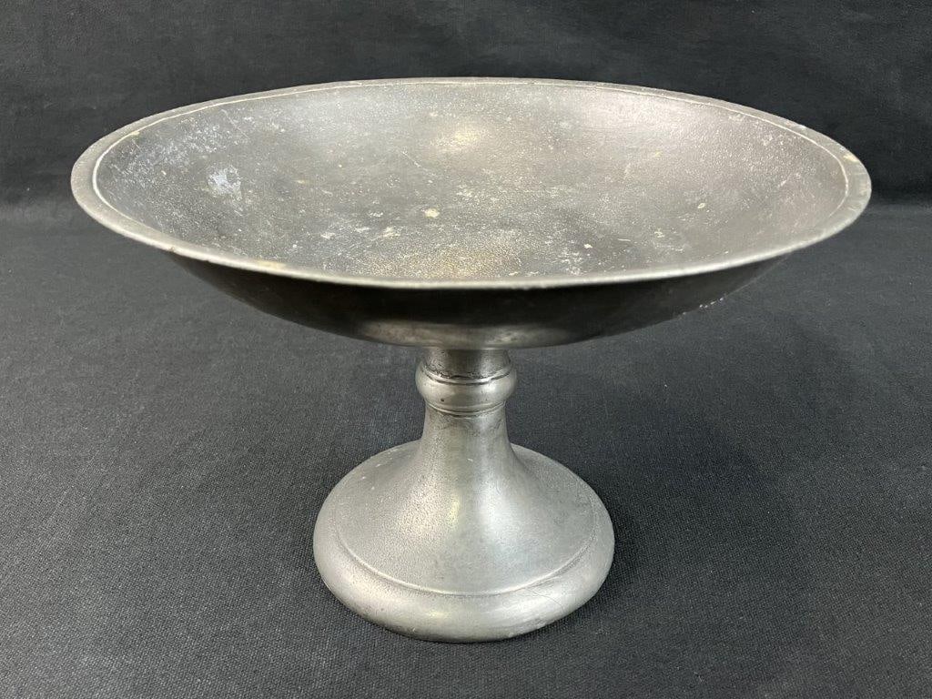 Pewter Compote: Simple and classic pewter compote with a clean pedestal form. Measures approximately 6â€³ H x 9 1/8â€³ in diameter. General wear.