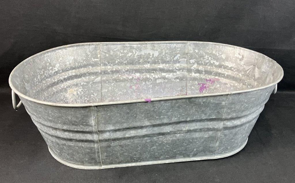 Metal Garden Planter: Galvanized metal planter with a substantial form and two side handles, suitable for garden or decorative use. Measures approximately 7â€³ H x 22 1/2â€³ W x 12