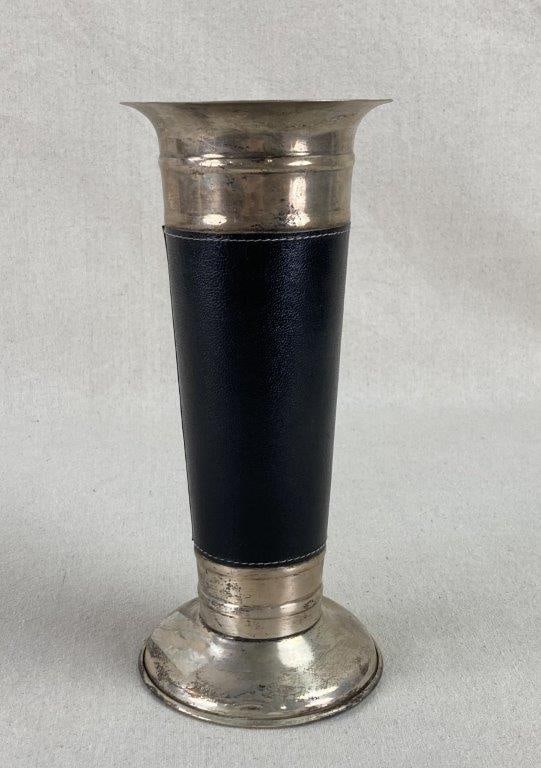 Leather Wrapped Silver Plate Vase: This sophisticated silver plate vase blends sleek metallic form with tactile, equestrian-inspired detailing, featuring a sturdy round base and a gracefully flared rim. The mid-section is elegantly