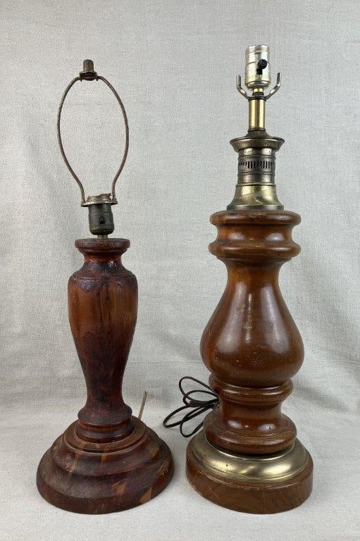 Two Turned Pine Lamps: Two pine wood table lamps with turned forms and a rustic country aesthetic, featuring brass hardware and accents. Tallest measures approximately 23 1/4″ H x 6″ in diameter. General wear