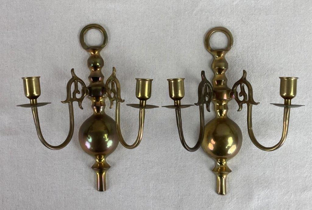 Brass Wall Sconces: This pair of solid polished brass wall sconces offers a bright, traditional elegance that instantly elevates a room's architectural detail. Each sconce features two scrolling arms extending from a