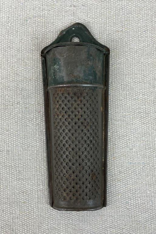 Metal Nutmeg Grater: Metal nutmeg grater with hinged lid, displaying a rustic patina and classic utilitarian form. Measures approximately 5â€³ H x 1 7/8â€³ W x 1â€³ D.