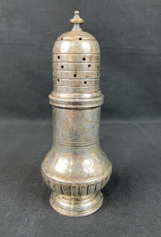 Silverplate Muffineer: Silverplate muffineer in a traditional, elegant form, typically used for sugar or powdered condiments. Measures approximately 7 1/2â€³ H x 3â€³ in diameter. General