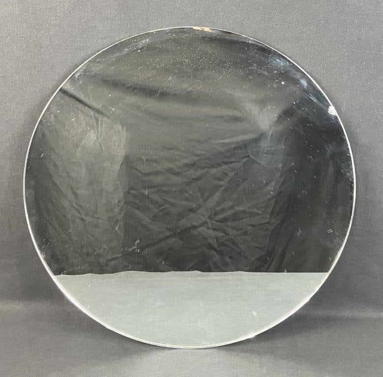 Glass Mirrored Display: Round table top mirrored glass display with a simple reflective surface, suitable for decorative presentation. Measures approximately 1/8â€³ H x 17 7/8â€³ in diameter. 