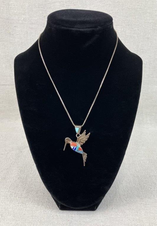 Calvin Begay Navajo Inlaid Hummingbird Necklace: This sterling silver mosaic stone inlay pendant by Navajo silversmith Calvin Begay is crafted in the depiction of a hummingbird in flight, intricately inlaid with turquoise, lapis lazuli, lab-created
