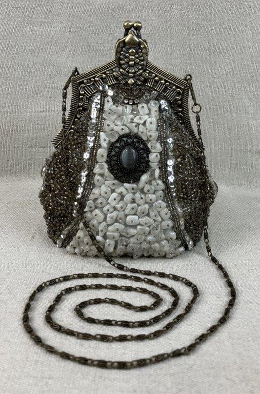 Victorian Trading Annalise Purse: This highly detailed Victorian Trading "Annalise" purse features a brass-tone metal top frame embellished with floral and geometric embossing and a classic kiss lock. The structured fabric body is