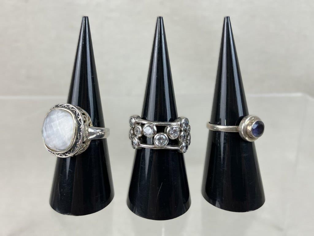 Vintage Sterling Silver Rings with Silver-tone Ring: This three-piece collection of vintage rings features two pieces crafted from sterling silver alongside a classic costume design. The assortment includes a costume silver-tone ring showcasing a clear 