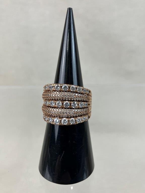 Sterling Silver Vermeil Ring: A beautiful sterling silver ring featuring a multi-row display of clear faceted gemstones set against warm gold tones, with the interior of the band marked for silver content alongside a maker's mark