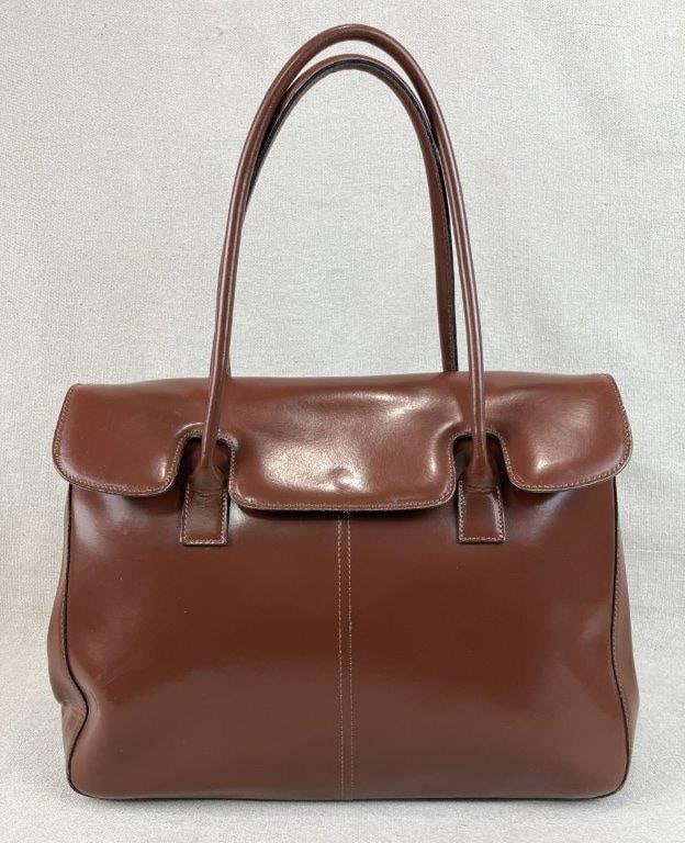 Cristian Leather Briefcase Tote Bag: A handsome smooth brown leather briefcase bag by Cristian featuring a sophisticated, stylized contour front flap and dual anchored top leather handles with unique flared base attachments. The